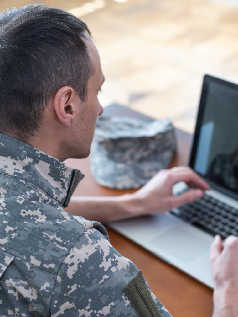 Veteran searching for jobs on a laptop