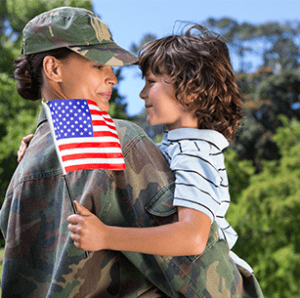 A veteran holding their child
